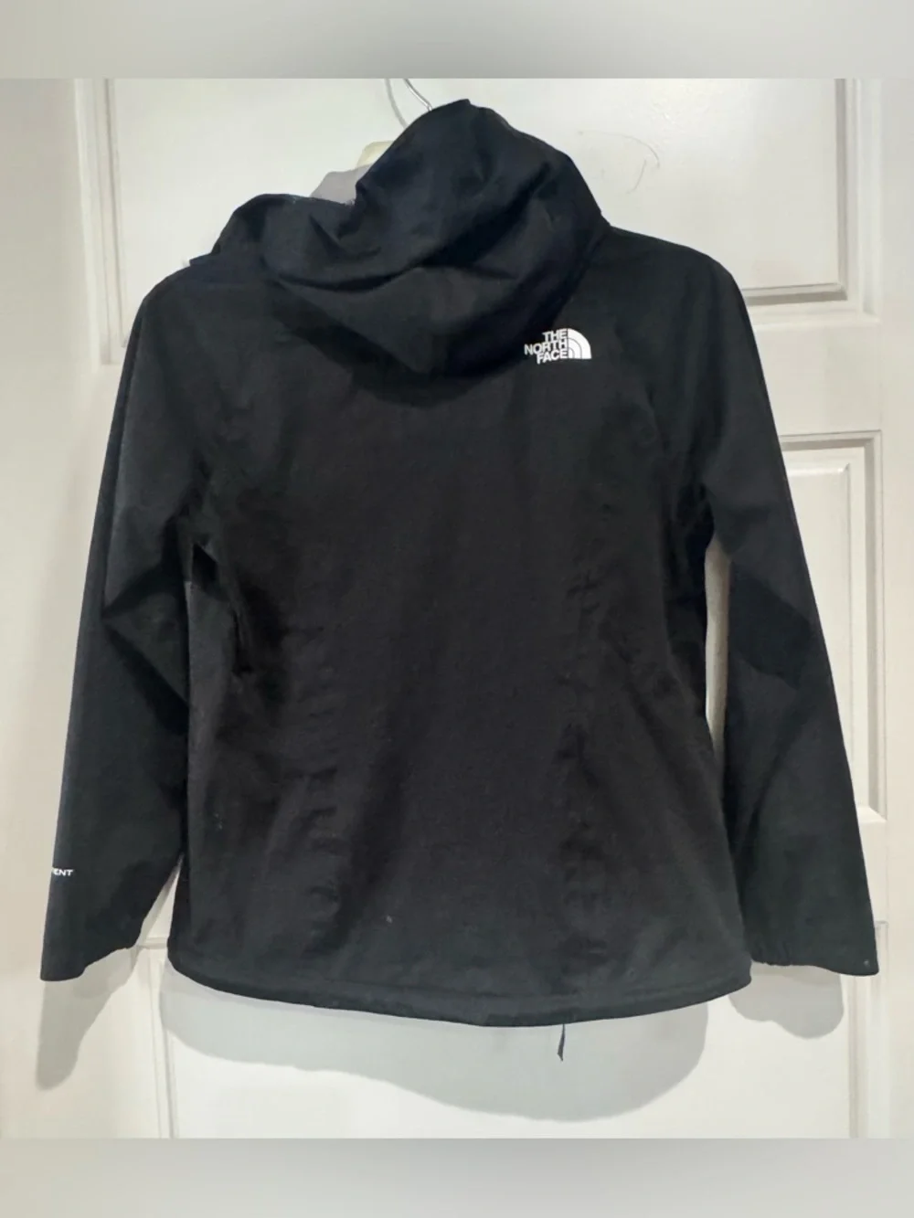 The North Face Black Raincoat with White Zippers and Logo